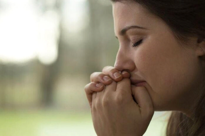 woman crying and praying